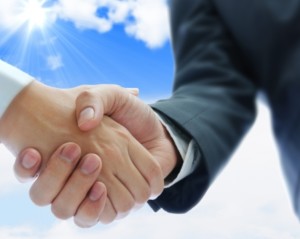 15321120 - business people shaking hands on blue sky background
